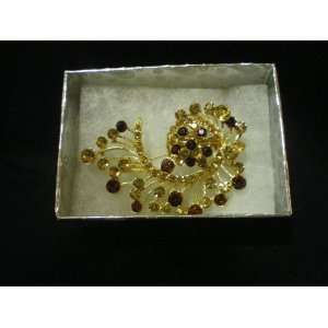 Gold Wavy Brooch Adorned Crystals and Brown Crystals 