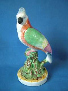 Staffordshire parrot perched on a branch figure  